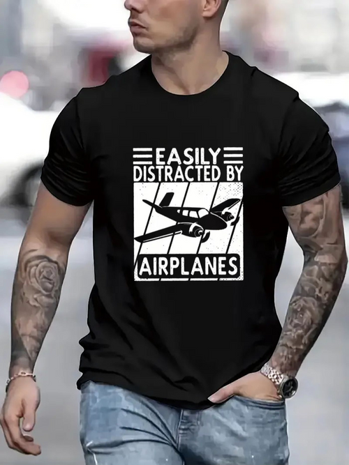 Men's Graphic T-Shirt Easily Distracted By Airplanes Flying Over Urban Skyline With Single Propeller Airplane