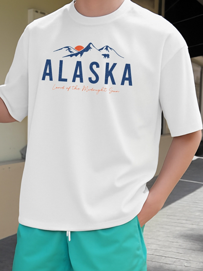 Men's Graphic T-Shirt Alaska Mountain Illustration With Orange Sun And Blue Skyline