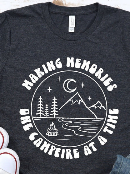 Men's Graphic T-Shirt Making Memories Under Crescent Moon Beside River With Pine Trees And Campfire Mountain